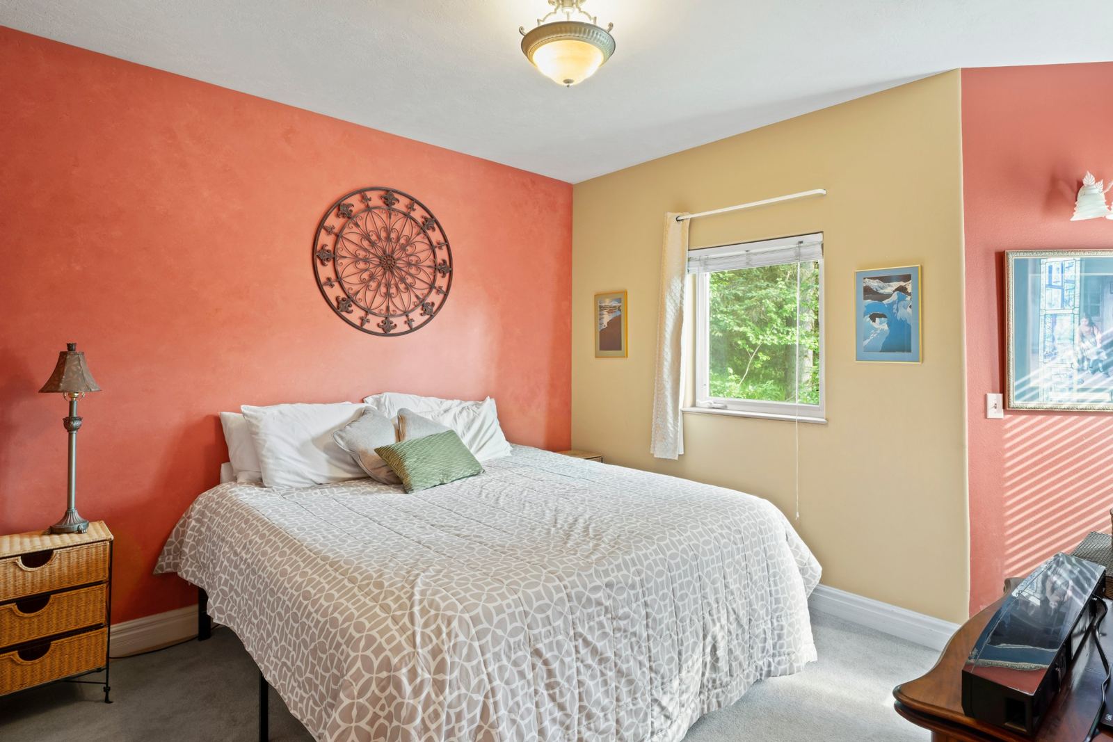 Bedroom with a queen bed and coral walls