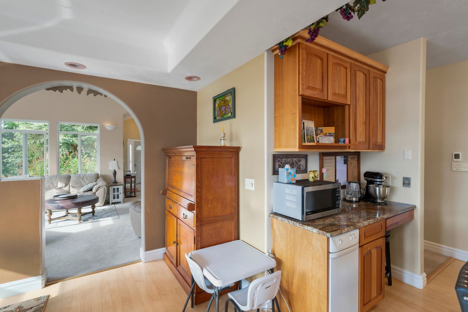 Coffee and microwave nook beside an arch into the living room