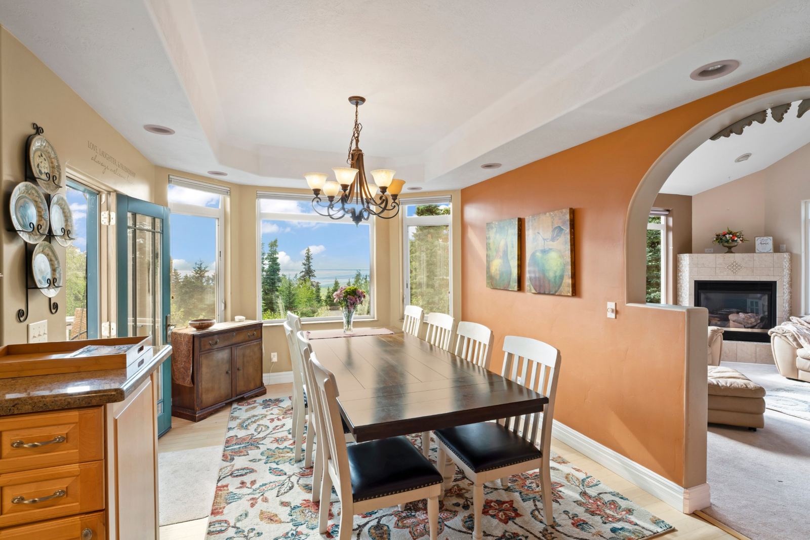 Dining table seating ten beside bay windows looking over Cook Inlet