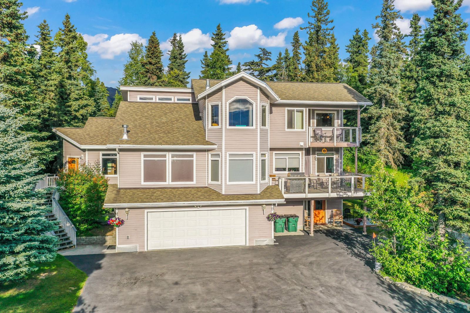 Hillside Haven from the air on its wooded lot