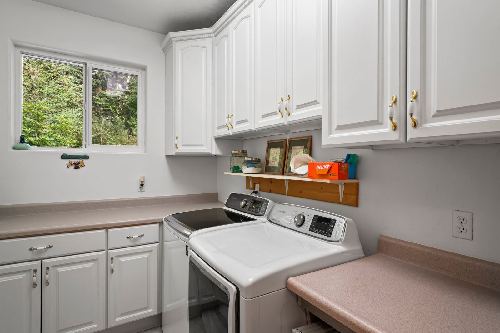 Laundry room with washer, dryer and folding counters