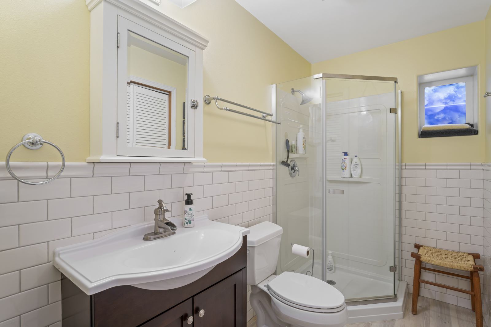 Lower-level bathroom with a corner glass shower and subway tile