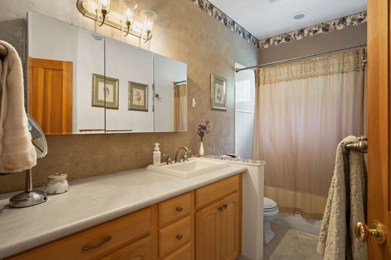 Main-floor bathroom with a long vanity and tub-shower